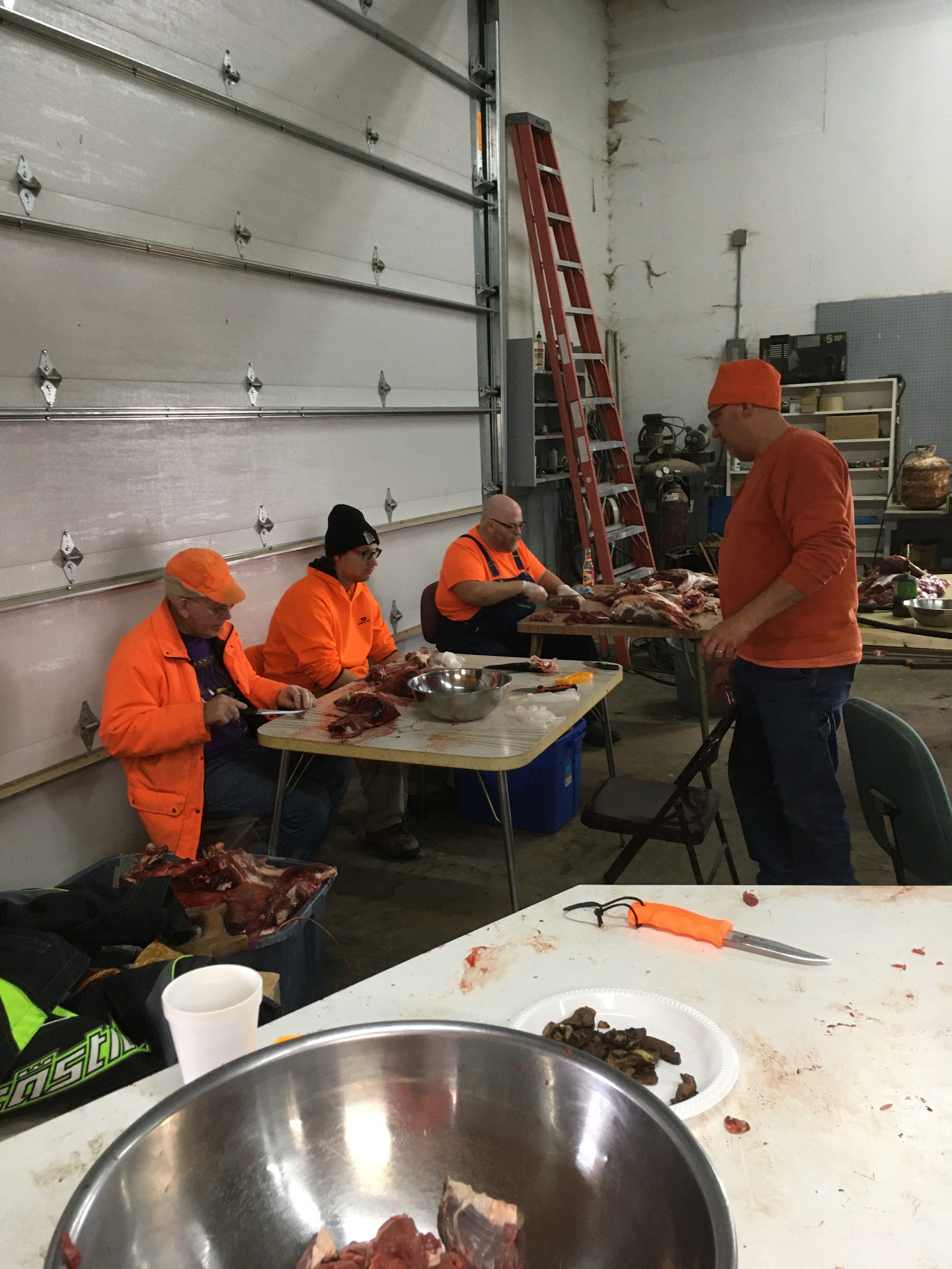 Glenn, Tony, Jared cutting meat