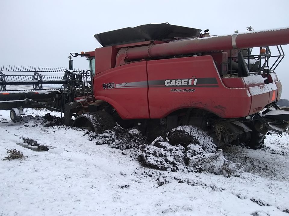 Combine stuck farming on a cold wet year